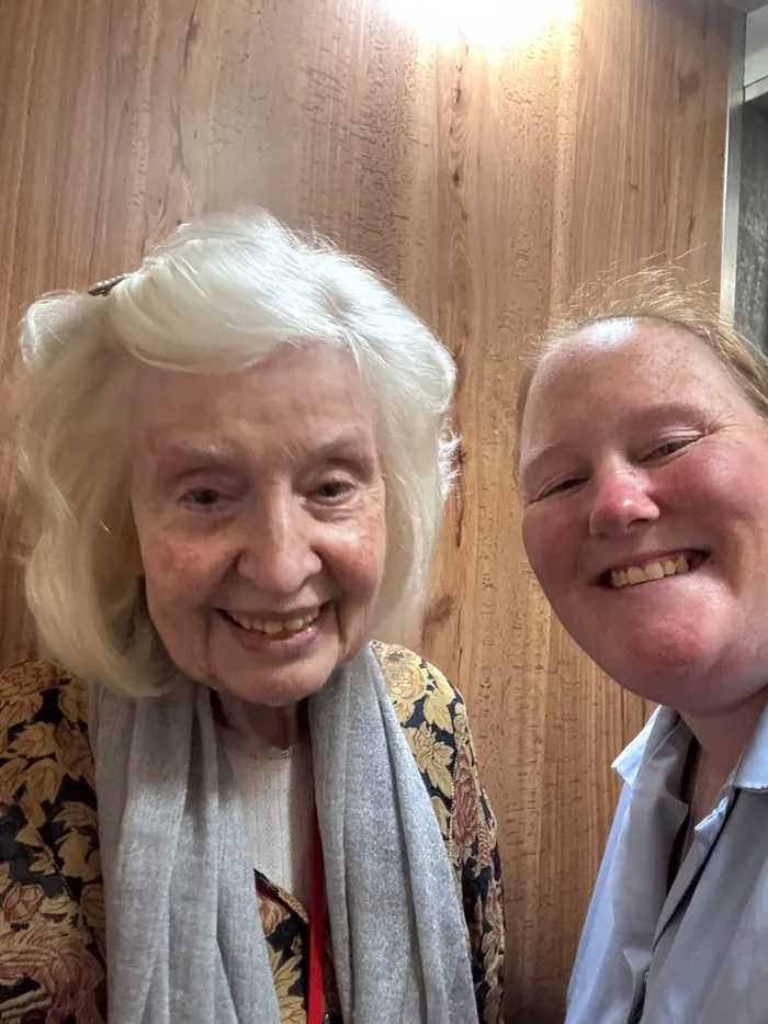 A resident and a member of the care team smiling together in a selfie